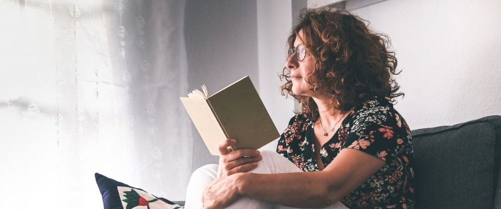 A couple recline together and smile at one another